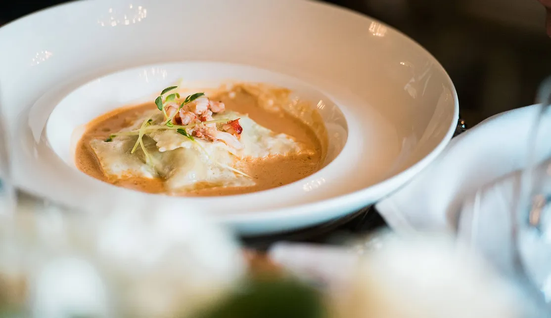 Gourmet lobster ravioli plated for an upscale catered dinner