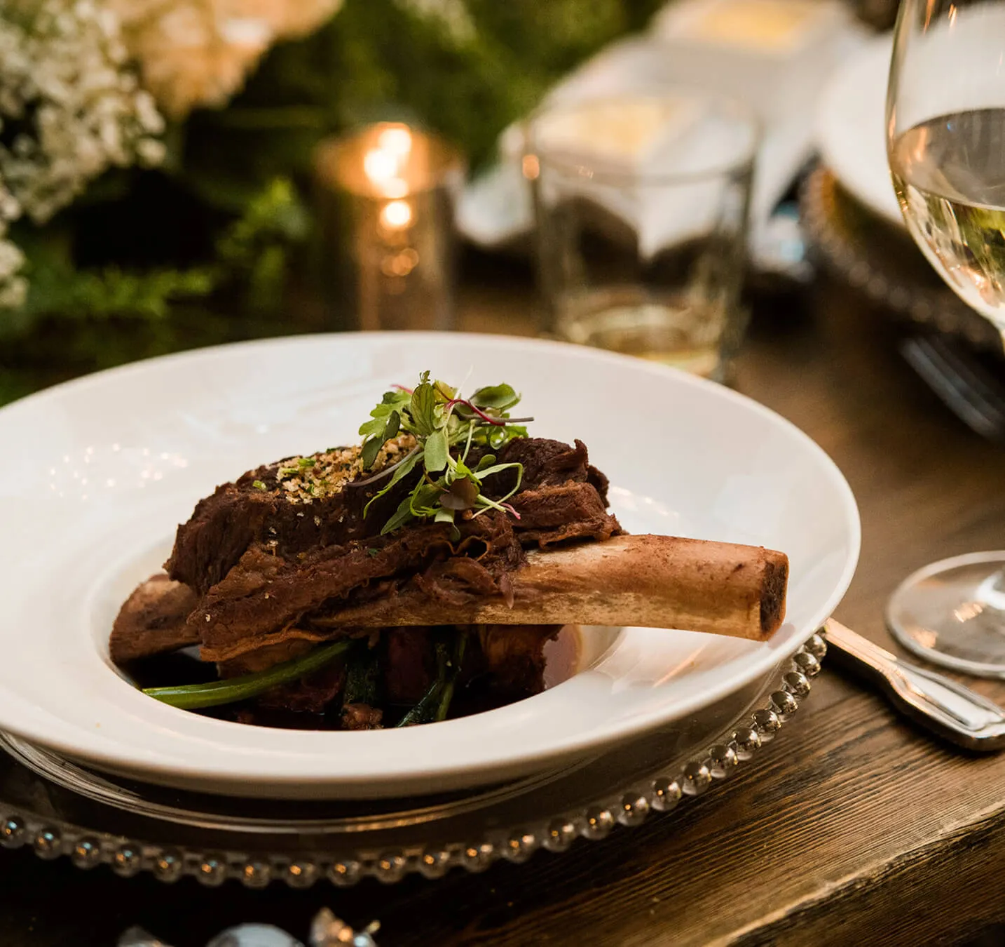 Braised beef short rib plated with microgreens for a fine dining event