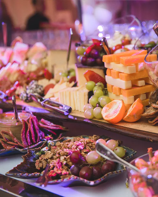 Charcuterie and cheese tower display at an evening catered event