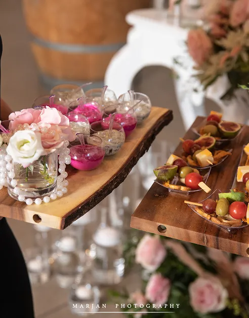 Passed hors d'oeuvres on live-edge boards at a formal catered event
