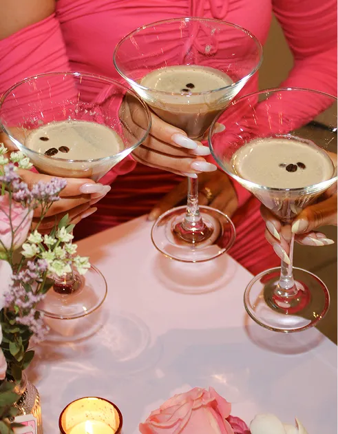 Guests toasting with espresso martinis at a celebration