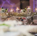 Floating candle centerpieces with moss and white florals